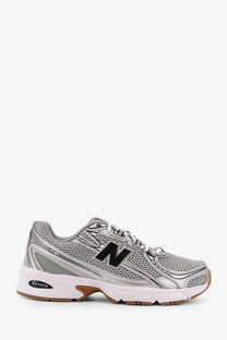New Balance men’s low top grey sneakers with silver white mesh upper black logo and gum-colored outsole