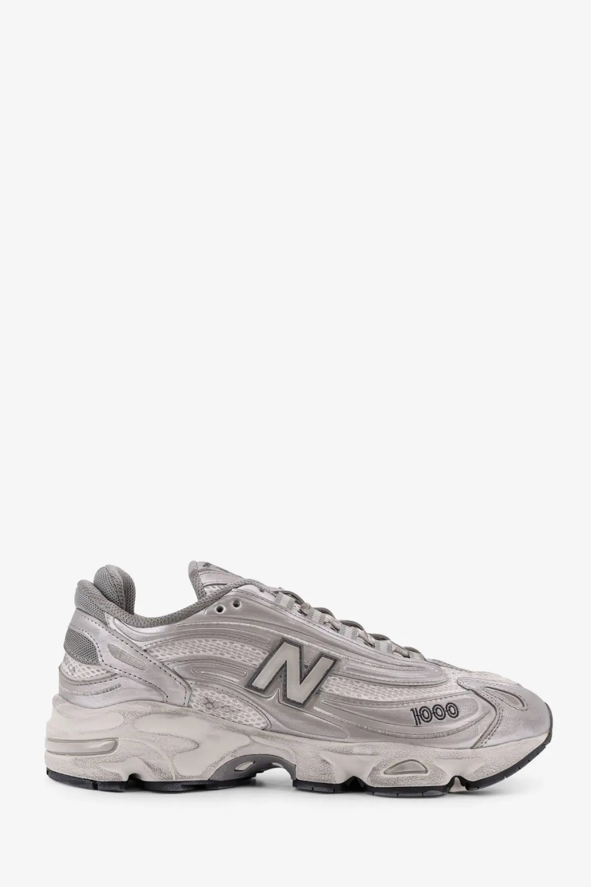 New balance men’s low top mesh sneakers in silver featuring a chunky textured sole and breathable mesh upper