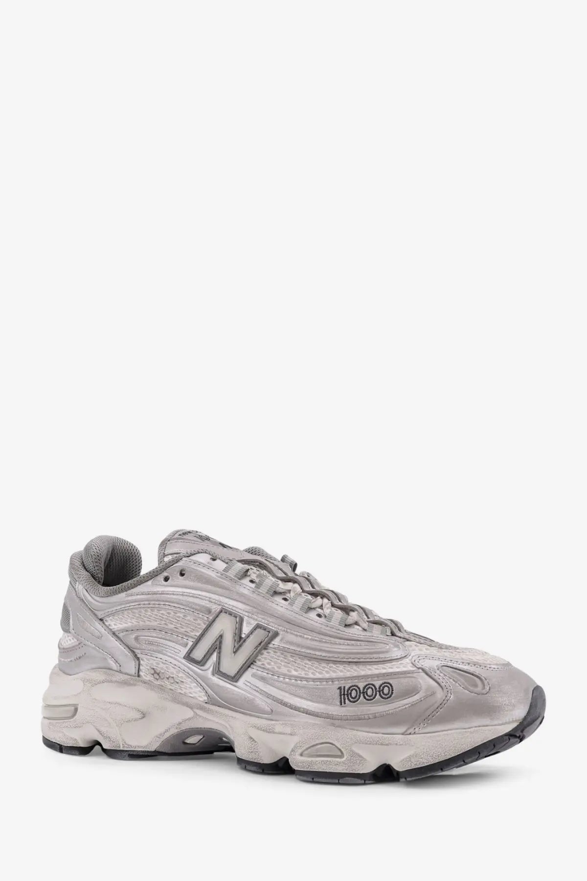 New Balance men’s low top silver sneaker with chunky layered design and textured mesh upper