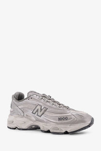New Balance men’s low top silver sneaker with chunky layered design and textured mesh upper