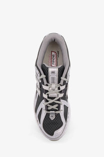 New balance men’s low top mesh sneakers in gray and black with white laces and silver accents on the upper