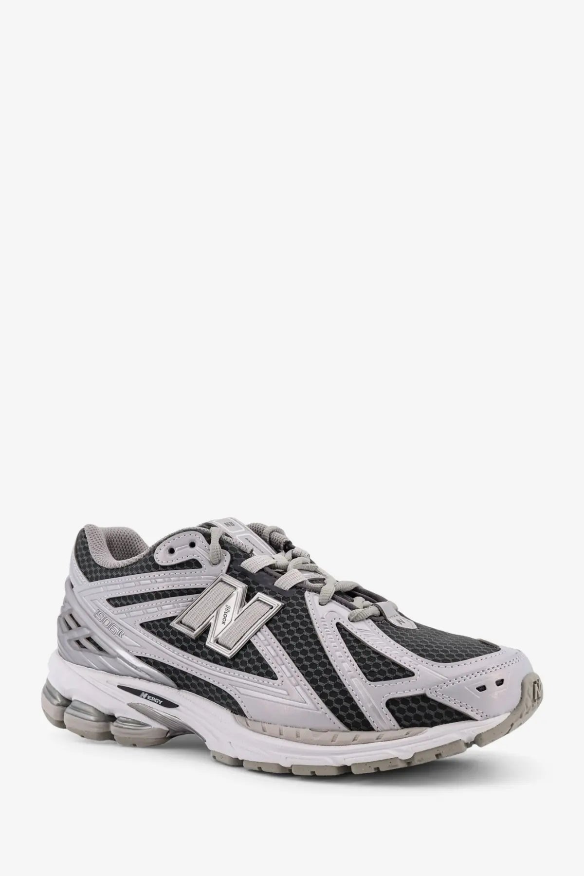 New balance men’s low top mesh sneakers in gray and black with synthetic overlays and silver n logo on the side