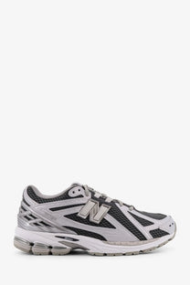 New balance men’s low top mesh sneakers in gray and black with metallic silver logo and cushioned midsole
