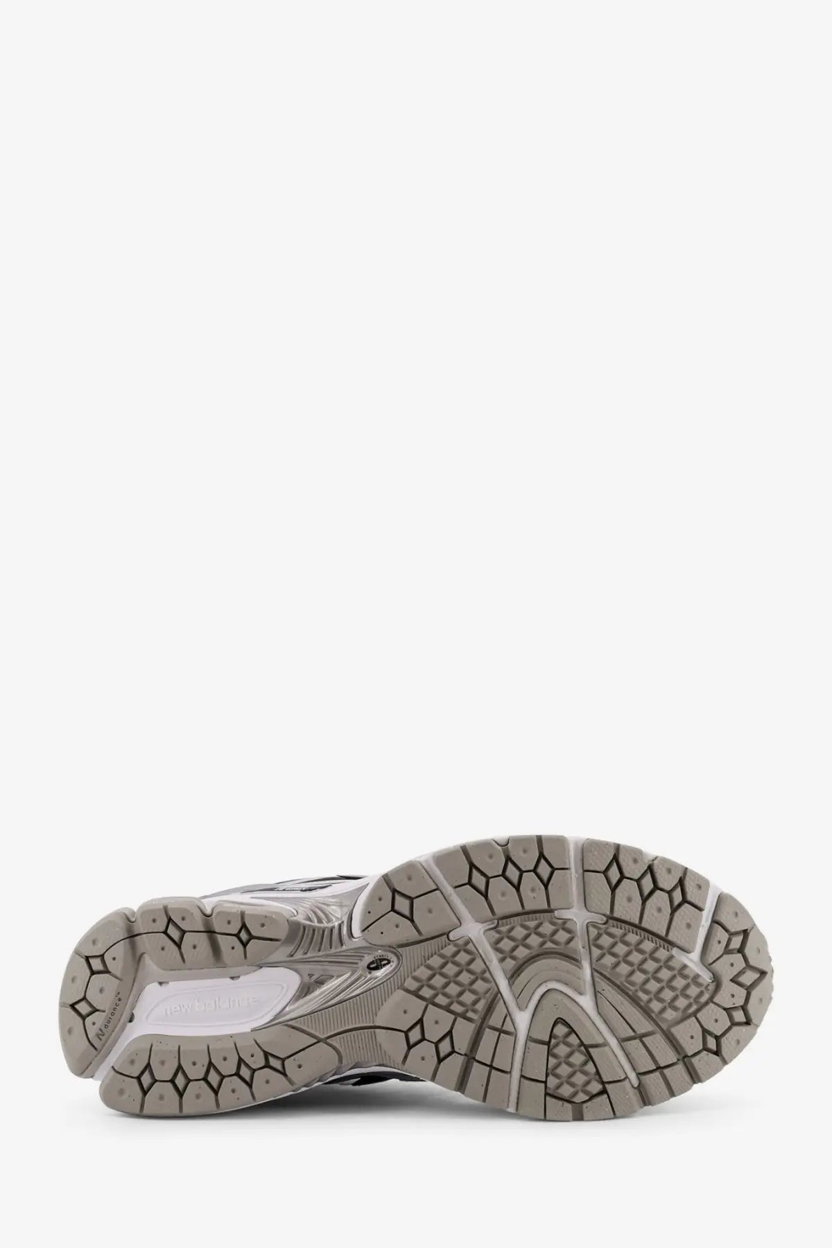Gray and white rubber sole with geometric tread pattern on new balance men’s low top mesh white sneaker