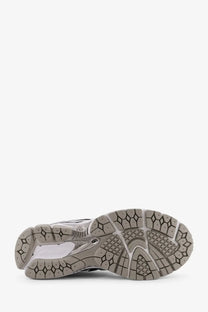 Gray and white rubber sole with geometric tread pattern on new balance men’s low top mesh white sneaker