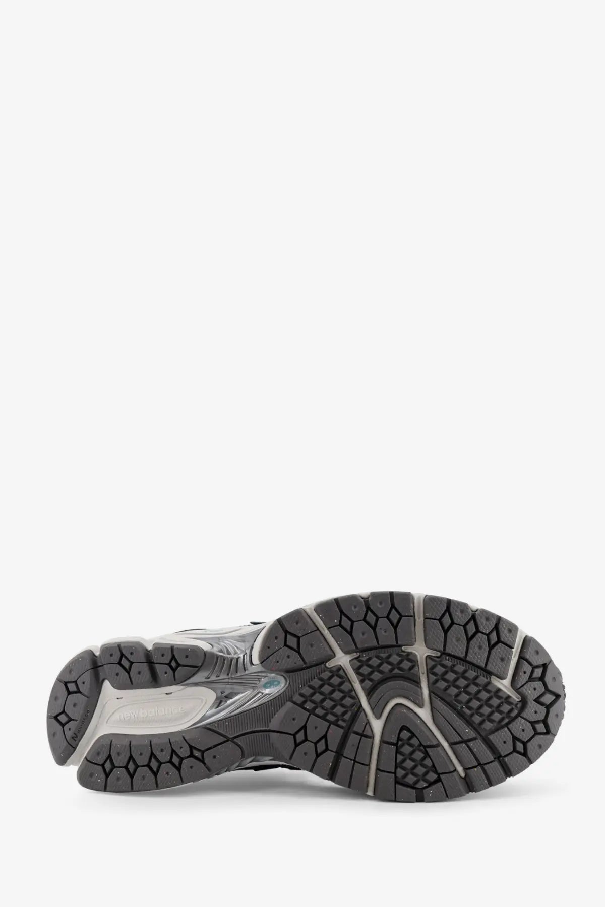 New balance men’s mesh sneakers blue showing black and gray rubber sole with textured geometric tread pattern