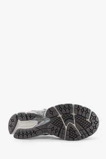New balance men’s mesh sneakers blue showing black and gray rubber sole with textured geometric tread pattern