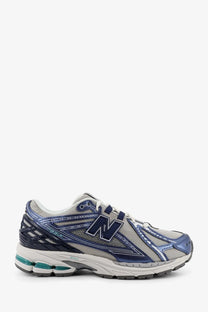New Balance men mesh sneakers in blue and gray with mesh upper metallic accents and teal cushioning