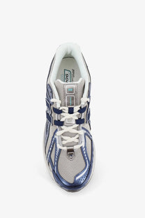New Balance men’s mesh sneakers blue gray and navy running shoe with mesh upper metallic accents and white laces