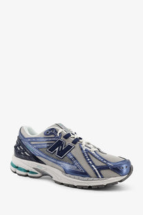 New balance men’s mesh sneakers blue with blue and gray mesh upper, metallic blue accents, white laces, and teal heel cushioning