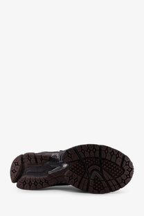 Black rubber sole with textured geometric tread and translucent accents on new balance men’s mesh sneakers grey
