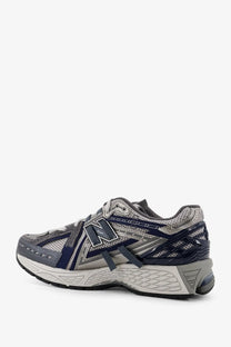 New balance men’s mesh sneakers grey featuring gray and navy blue running shoe with mesh and synthetic overlays