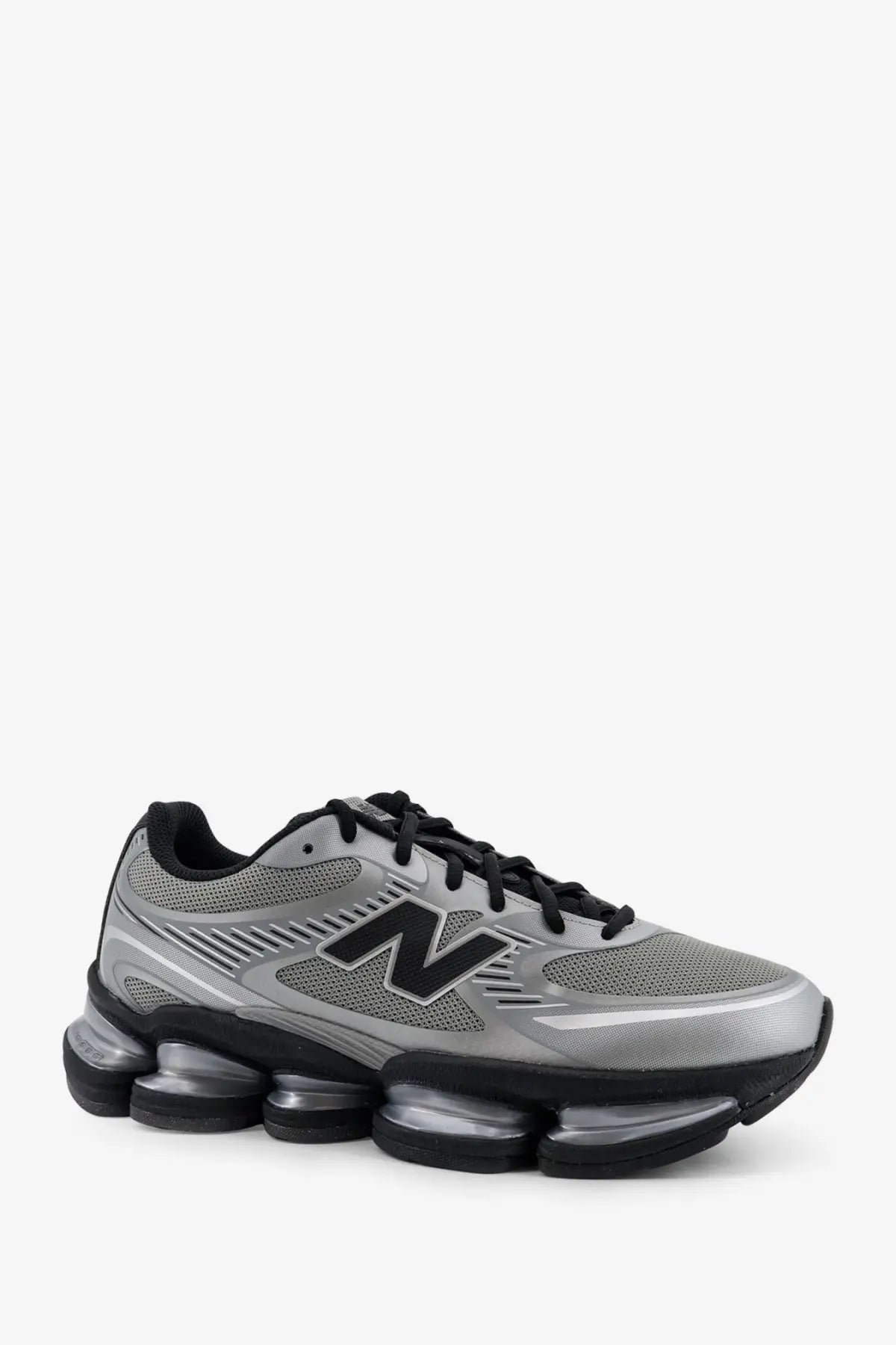 New balance men’s mesh sneakers grey featuring silver and black mesh upper and distinctive air-cushioned sole