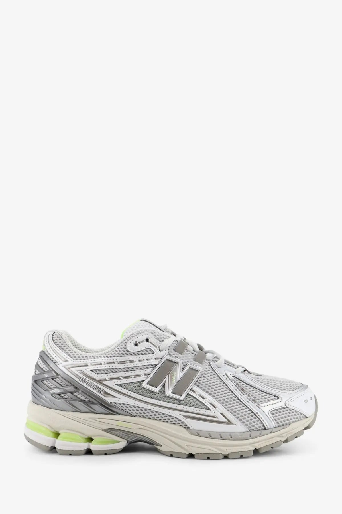 New Balance men’s mesh sneakers in silver and white with gray branding and lime green midsole