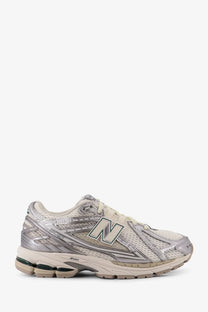 New Balance men’s mesh sneakers silver featuring silver and beige mesh upper with metallic accents and cushioned sole