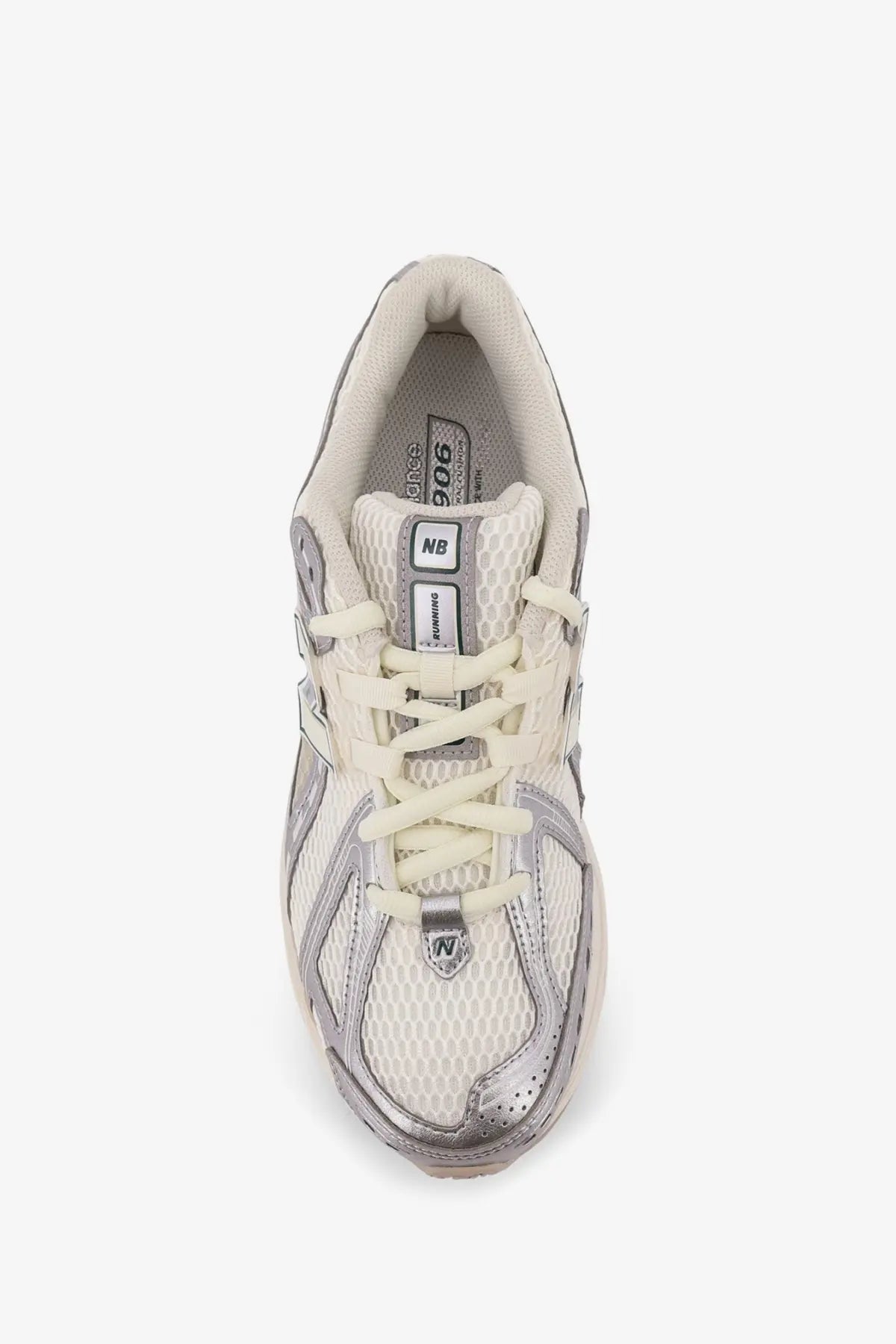Cream-colored new balance 906 men’s mesh sneakers with metallic silver accents and breathable mesh material