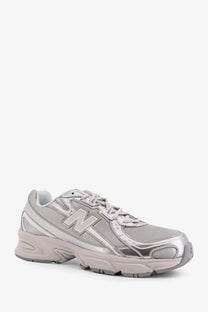 New balance men’s silver sneaker with mesh and synthetic overlays for lightweight comfort and style