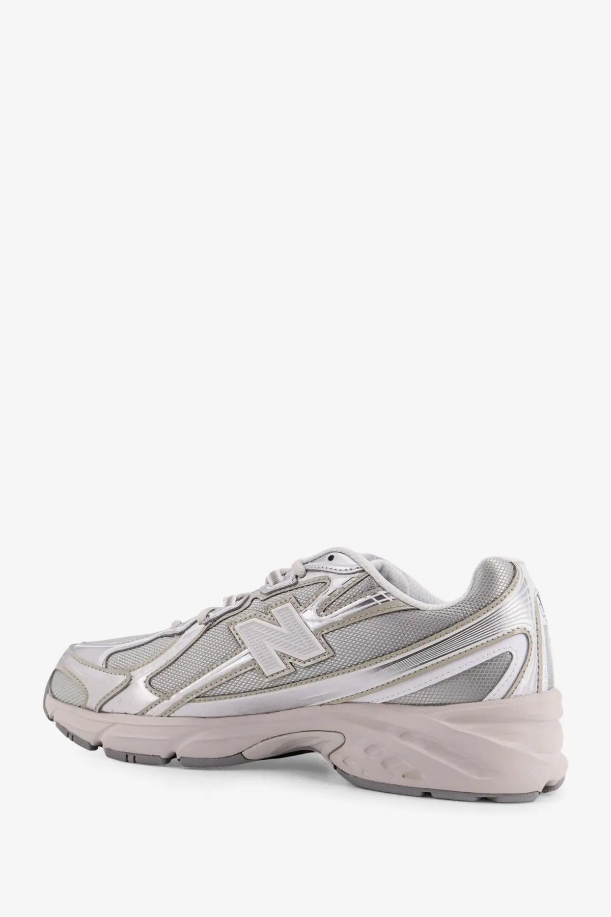 New Balance men’s silver sneaker with mesh and synthetic overlays featuring a chunky midsole