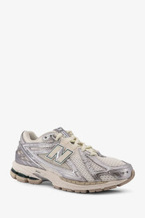 New balance men’s mesh sneakers silver featuring silver and off-white mesh upper with metallic overlays and cushioned sole