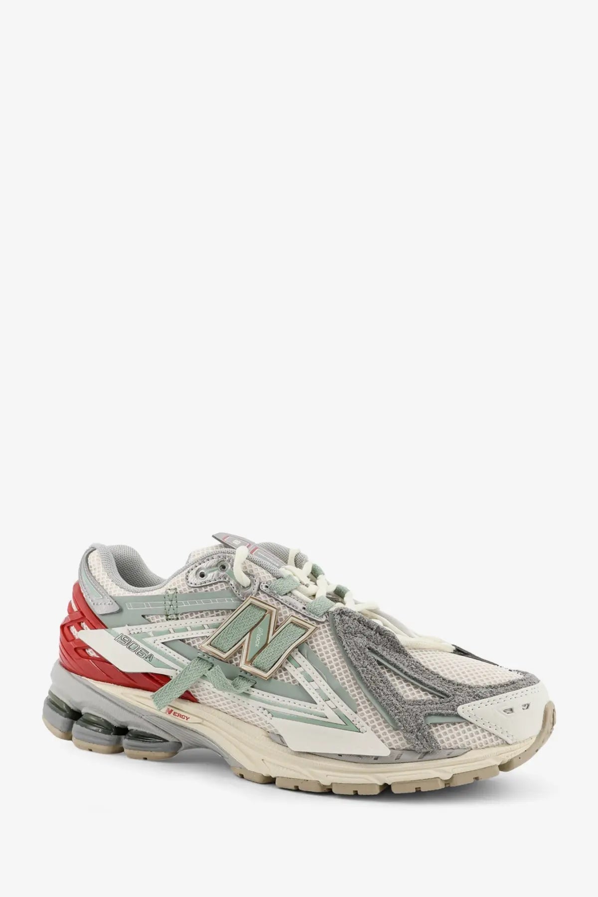 New Balance men’s mesh sneaker in white with gray red mesh and metallic silver accents featuring 2016 model design