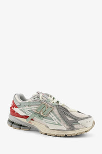 New Balance men’s mesh sneaker in white with gray red mesh and metallic silver accents featuring 2016 model design