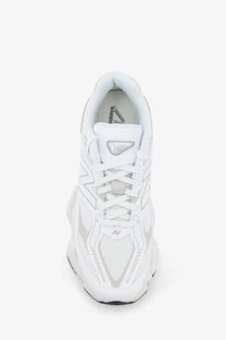 New balance men’s mesh sneakers white featuring a sleek white athletic shoe with gray accents on mesh upper