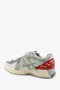 New balance men’s mesh sneakers in gray and red with synthetic overlays and chunky midsole for casual wear