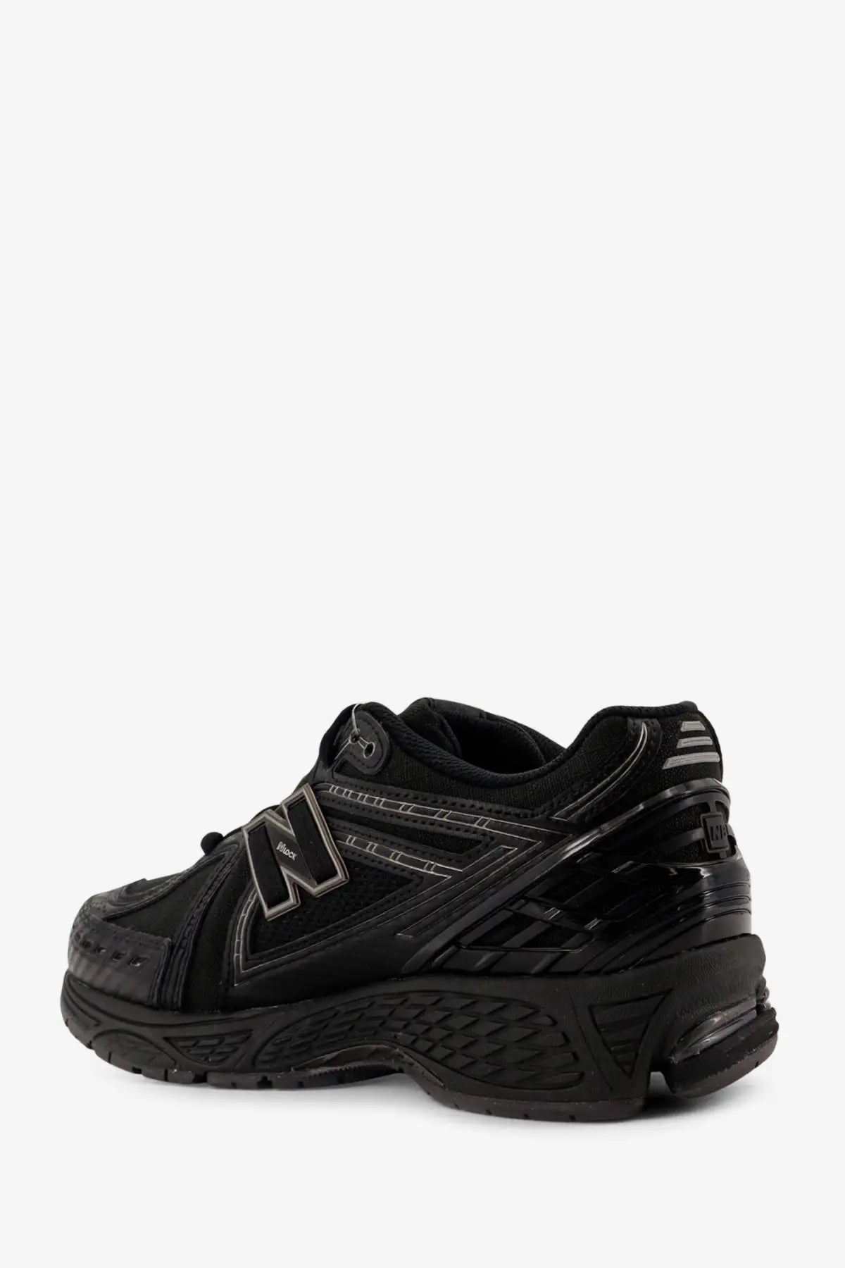 New balance men’s nylon sneakers black featuring a glossy finish with subtle gray logo and midsole accents