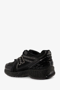 New balance men’s nylon sneakers black featuring a glossy finish with subtle gray logo and midsole accents