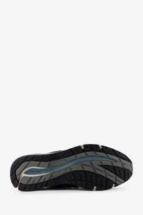 New balance men’s suede low top sneakers in blue featuring a black and gray merrell running shoe with blue accent stripe