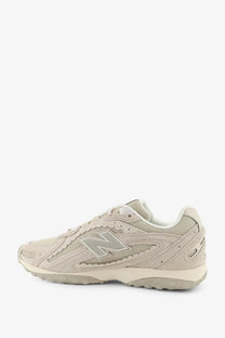 New balance men’s green sneaker with beige suede and mesh upper and gray logo accent
