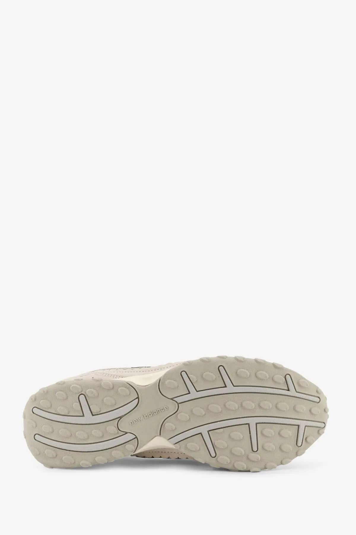 Beige rubber sole with textured tread and new balance logo on green suede and mesh men’s sneakers