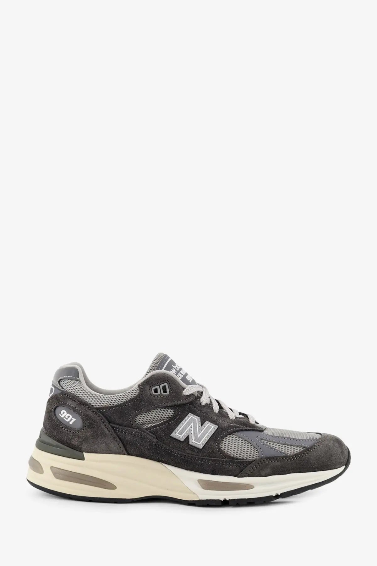 New Balance men’s grey sneaker in dark gray suede and mesh with cream-colored midsole for casual wear