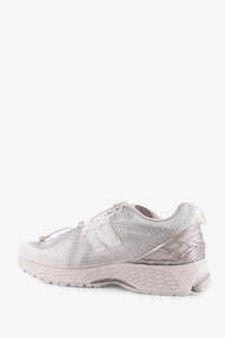 Silver new balance men’s sneaker with textured mesh upper and translucent overlays in technical fabric design