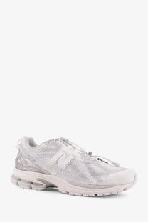New balance men’s technical fabric sneaker in sleek all-white with textured mesh upper and translucent rubber sole