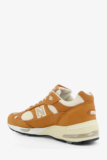 New balance men’s tier leather sneakers beige tan 990v3 with white accents and visible air unit in the heel
