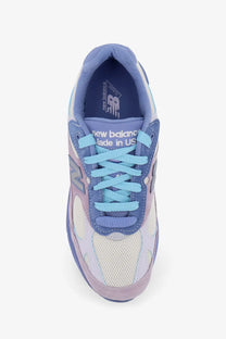 New Balance unisex mesh and suede sneaker in pastel blue and lavender with white rubber sole and light blue laces