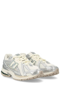White and silver new balance 2003 sneaker with mesh upper metallic accents and beige rubber sole for unisex use