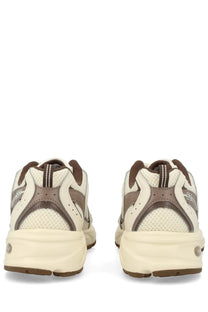 New Balance unisex sneaker beige cream and brown athletic shoe with mesh and synthetic overlays and chunky midsole