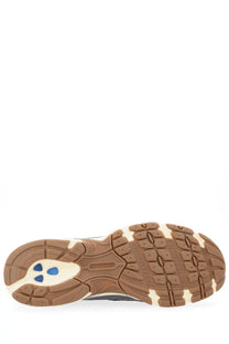 New Balance unisex sneaker black featuring a brown and cream rubber sole with blue accents and New Balance logo