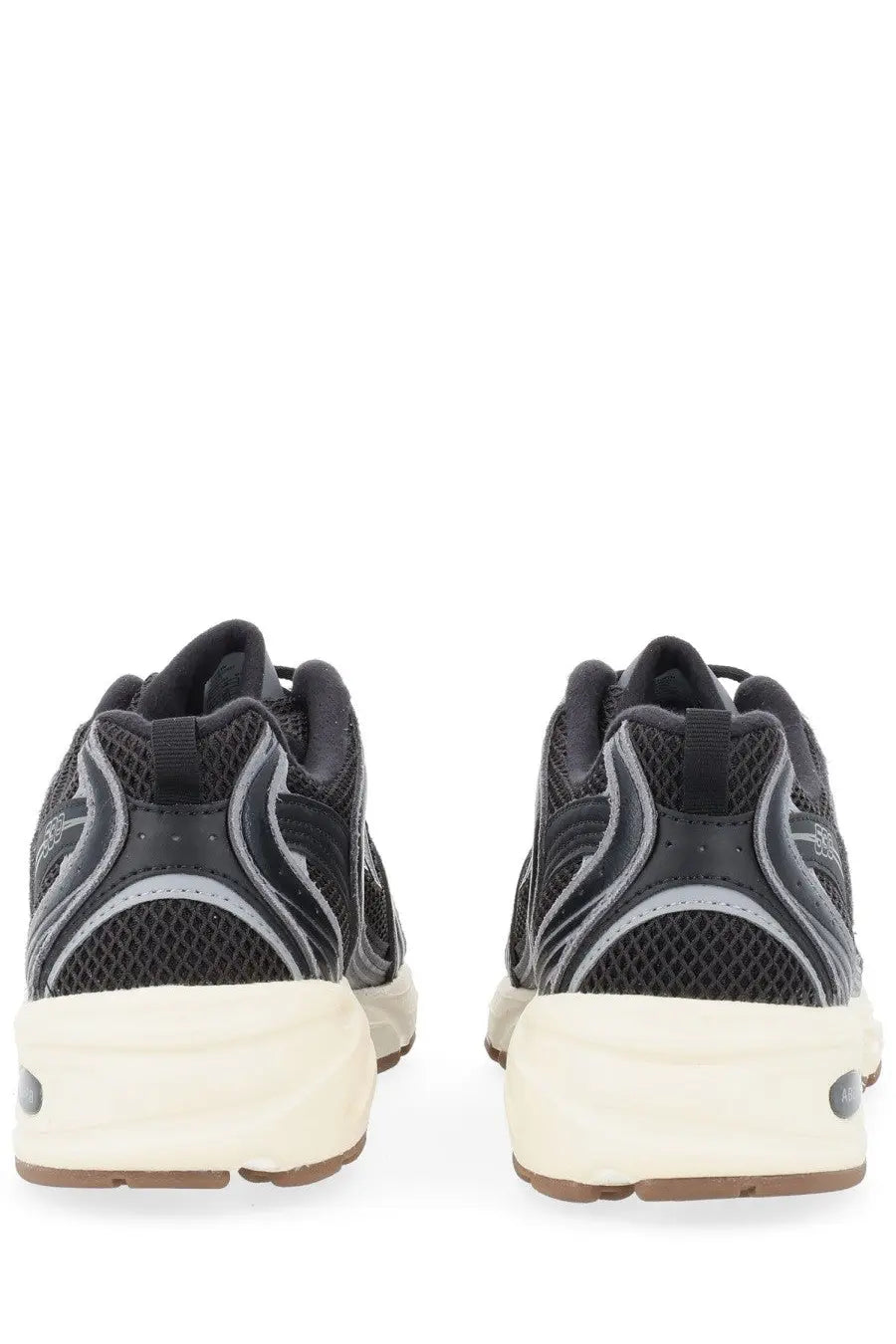 New Balance unisex sneaker black featuring black and gray mesh upper, cream midsole, and brown outsole in athletic style