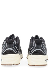 New Balance unisex sneaker black featuring black and gray mesh upper, cream midsole, and brown outsole in athletic style