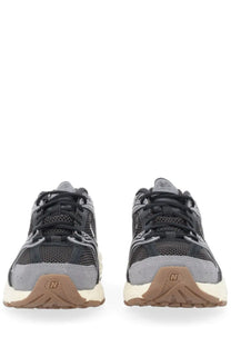 New balance unisex sneaker black with black and gray mesh upper and tan rubber sole featuring classic design
