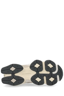 New Balance unisex sneaker grey with cream-colored upper and black rubber outsole featuring diamond tread patterns