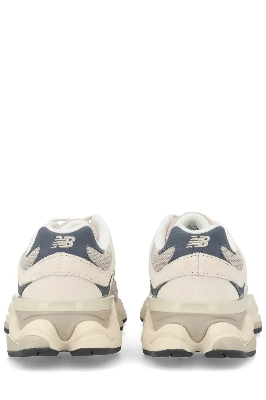Cream-colored new balance unisex sneaker with navy blue accents and a chunky textured sole in grey style