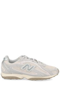 Light gray new balance unisex sneaker with suede and mesh upper featuring silver n logo on the side
