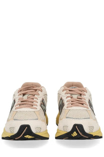 New Balance unisex sneaker U2010 multicolor featuring cream and yellow mesh uppers with black accents