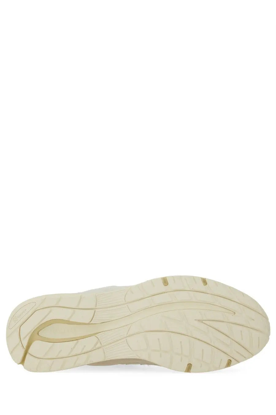 Cream-colored rubber sole of new balance unisex sneaker u991 white with sleek tread pattern and gold accent lines