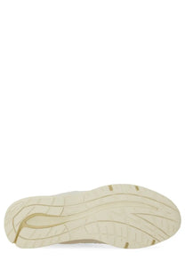 Cream-colored rubber sole of new balance unisex sneaker u991 white with sleek tread pattern and gold accent lines