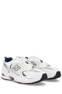 New Balance unisex sneaker white featuring white mesh and synthetic overlays with silver and navy accents
